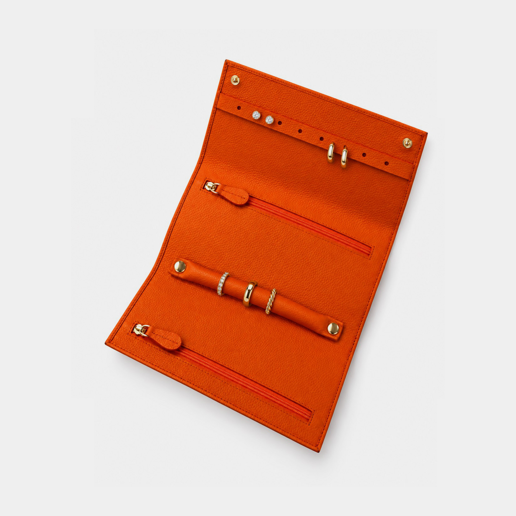 Personalised leather jewellery roll with zip compartments, ring loops and earring holes.