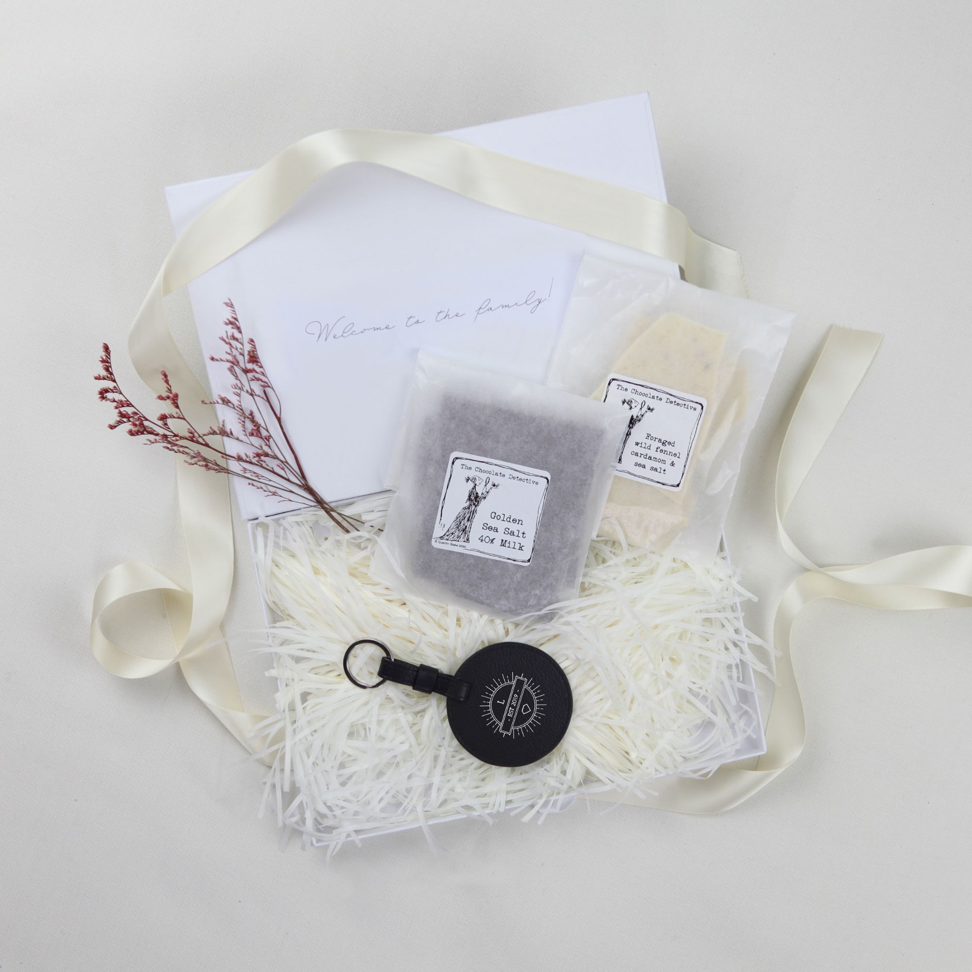 Appreciation gift box with branded leather round keyring and milk, white, dark chocolates