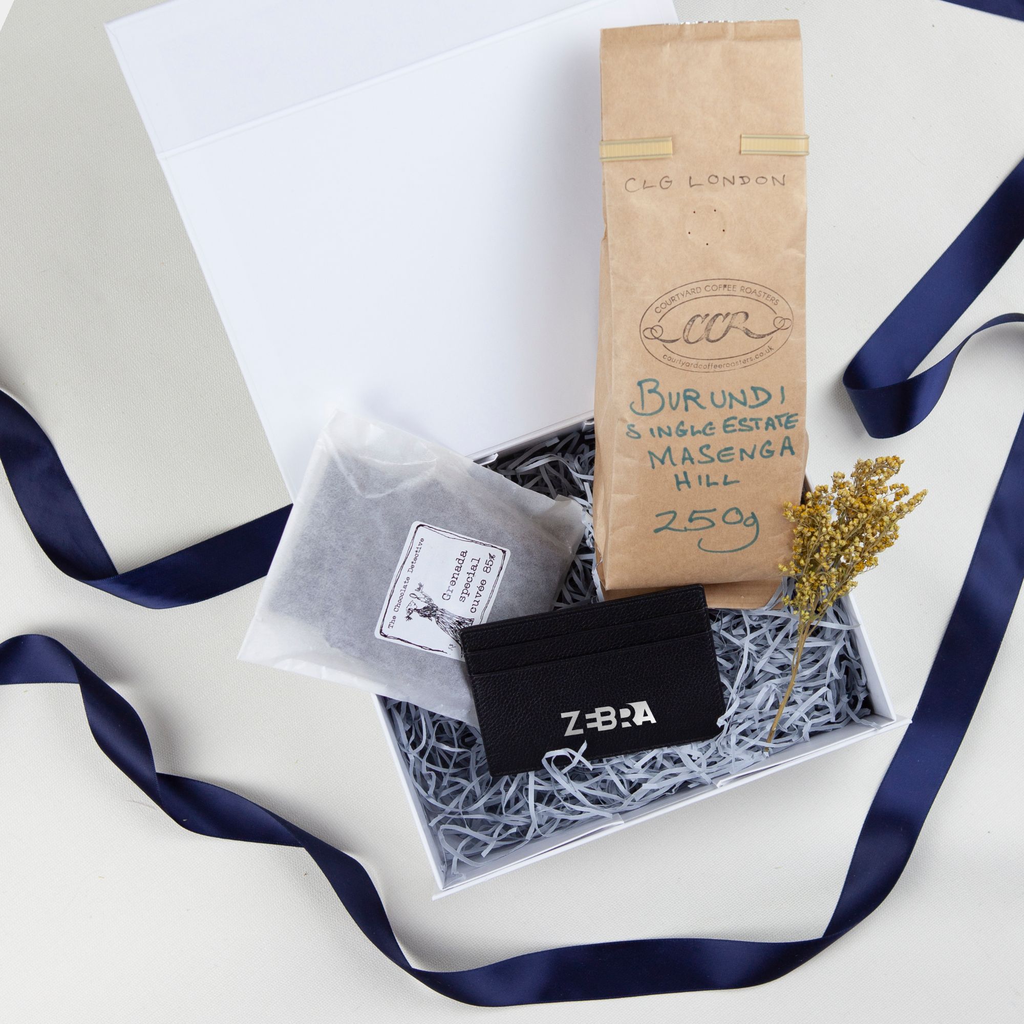 Gift box for employees and clients with branded leather card case and milk, dark, white chocolate and ground coffee, coffee beans.